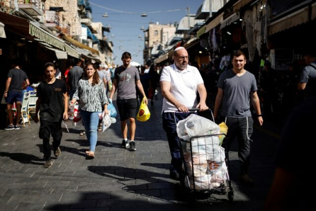 Consumidores transportam suas compras no mercado Mahane Yehuda, em Jerusalém