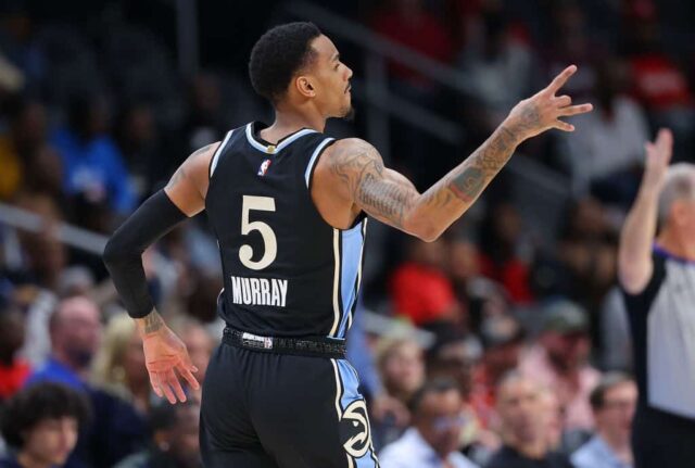 Dejounte Murray, nº 5 do Atlanta Hawks, reage após acertar uma cesta de três pontos contra o Milwaukee Bucks durante o primeiro quarto na State Farm Arena em 30 de março de 2024 em Atlanta, Geórgia. 