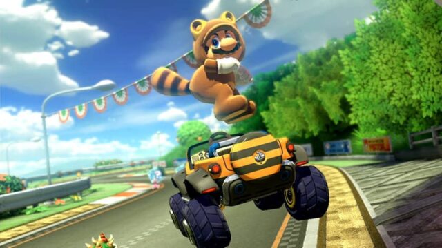 Mario em seu traje Tanooki (semelhante a um guaxinim), pulando no ar e enfiando a bunda acima de seu off-roader listrado.