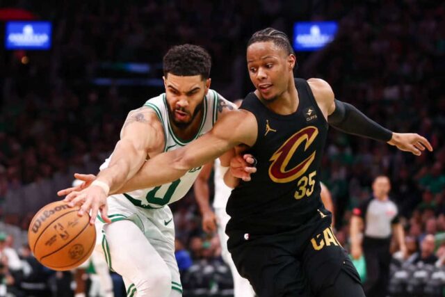 Jayson Tatum #0 do Boston Celtics e Isaac Okoro #35 do Cleveland Cavaliers lutam pela bola durante o terceiro quarto no primeiro jogo dos playoffs da segunda rodada da Conferência Leste no TD Garden em 07 de maio de 2024 em Boston, Massachusetts.