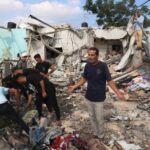 Um homem palestino reage enquanto as pessoas verificam os danos em uma casa atingida pelo bombardeio israelense em Zawayda, no centro da Faixa de Gaza, em 7 de julho de 2024. Israel realizou ataques aéreos mortais na Faixa de Gaza em 7 de julho, durante a guerra entre Israel e o Hamas O movimento entrou no seu 10º mês, com combates intensos em todo o território palestiniano e novos esforços diplomáticos em curso para pôr fim à violência.  (Foto de Eyad BABA/AFP)