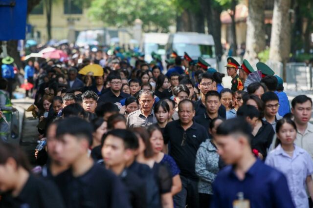 Pessoas fazem fila para visitar a funerária nacional para prestar homenagem ao falecido secretário-geral do Partido Comunista do Vietnã, Nguyen Phu Trong, em Hanói, em 26 de julho de 2024. (Foto de LUONG THAI LINH / POOL / AFP)