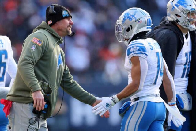 CHICAGO, ILLINOIS - 13 DE NOVEMBRO: O técnico Dan Campbell do Detroit Lions high fives Amon-Ra St. Brown # 14 do Detroit Lions durante o segundo tempo contra o Chicago Bears no Soldier Field em 13 de novembro de 2022 em Chicago, Illinois. 