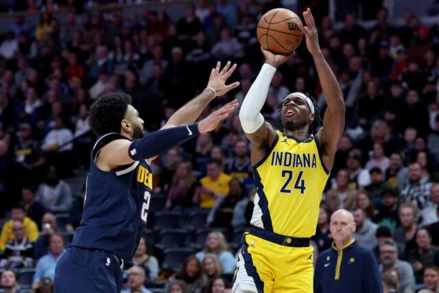 Buddy Hield nº 24 do Indiana Pacers arremessa contra Jamal Murray nº 27 do Denver Nuggets no primeiro quarto na Ball Arena em 20 de janeiro de 2023 em Denver, Colorado.