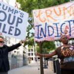 Manifestantes em Washington, DC, erguem cartazes que dizem